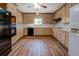 Kitchen features hardwood floors, stainless steel appliances and wood cabinets at 825 Sugar Creek Se Way, Conyers, GA 30094