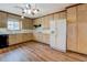 Traditional kitchen with light wood cabinets, a white refrigerator, and hardwood floors at 825 Sugar Creek Se Way, Conyers, GA 30094