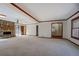 Open living room with stone fireplace, natural light and neutral carpet at 825 Sugar Creek Se Way, Conyers, GA 30094