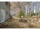 Backyard with stone patio, fire pit, built-in bench seating, and grill, perfect for outdoor entertaining and relaxation at 1390 Bridle Path Dr, Lawrenceville, GA 30045