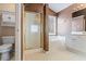 Bathroom featuring a glass shower door and a separate soaking tub by the window at 1390 Bridle Path Dr, Lawrenceville, GA 30045