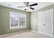 Bedroom featuring a window with a ceiling fan at 1390 Bridle Path Dr, Lawrenceville, GA 30045
