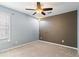 Bedroom featuring a ceiling fan and tan carpet at 1390 Bridle Path Dr, Lawrenceville, GA 30045