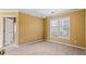 Neutral bedroom with carpet, window, and a ceiling fan at 1390 Bridle Path Dr, Lawrenceville, GA 30045