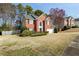 Charming brick two-story home with manicured lawn and attached two-car garage, neighborhood with mature trees at 1390 Bridle Path Dr, Lawrenceville, GA 30045