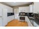 Bright kitchen features white cabinets, stainless appliances, and granite countertops at 1390 Bridle Path Dr, Lawrenceville, GA 30045