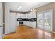 Spacious kitchen features stainless appliances, granite counters, and hardwood floors at 1390 Bridle Path Dr, Lawrenceville, GA 30045
