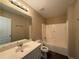 The bathroom contains a shower-tub combo, toilet, and vanity sink with a large mirror at 2728 Sandalwood Cir, Locust Grove, GA 30248