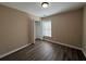 Bedroom with closet, window, and vinyl plank flooring at 2728 Sandalwood Cir, Locust Grove, GA 30248