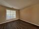 This bedroom features new dark wood floors, neutral walls, and a window with natural light at 2728 Sandalwood Cir, Locust Grove, GA 30248