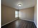 This bedroom features new dark wood floors, neutral walls, and natural light from a window at 2728 Sandalwood Cir, Locust Grove, GA 30248