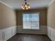 Dining room with modern lighting and wainscoting at 2728 Sandalwood Cir, Locust Grove, GA 30248