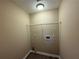 The laundry room has neutral colored walls with hookups, lighting, and a wire shelf at 2728 Sandalwood Cir, Locust Grove, GA 30248