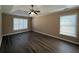 Spacious main bedroom featuring a tray ceiling and ceiling fan at 2728 Sandalwood Cir, Locust Grove, GA 30248