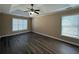 Spacious main bedroom featuring a tray ceiling and ceiling fan at 2728 Sandalwood Cir, Locust Grove, GA 30248