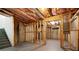 Unfinished basement featuring exposed insulation, framed walls, and stairs at 5720 Stow Dr, Tucker, GA 30084