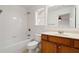 Bright bathroom featuring a tub/shower combo and a vanity with wood cabinets at 5720 Stow Dr, Tucker, GA 30084