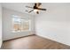 Bedroom features a ceiling fan, large window, and wood-look floors at 5720 Stow Dr, Tucker, GA 30084