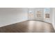 Bright, airy bedroom features beautiful bay windows, and modern wood-look flooring at 5720 Stow Dr, Tucker, GA 30084