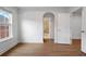 Sunlit bedroom boasts modern wood-look floors, crisp white trim, and attached bathroom at 5720 Stow Dr, Tucker, GA 30084