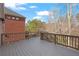 Large deck with a railing overlooking the tree-lined backyard at 5720 Stow Dr, Tucker, GA 30084