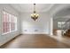 Elegant dining room with modern light fixture, trim detail, and beautiful hardwood floors at 5720 Stow Dr, Tucker, GA 30084