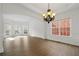 Formal dining room with hardwood floors, chandelier, and elegant trim detail at 5720 Stow Dr, Tucker, GA 30084