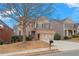 Beautiful two-story home with brick facade, mature trees, and an inviting driveway at 5720 Stow Dr, Tucker, GA 30084
