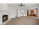 Open living room with hardwood floors, a fireplace, and a view into the kitchen at 5720 Stow Dr, Tucker, GA 30084