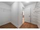 Walk-in closet with modern shelving and wood-look floors at 5720 Stow Dr, Tucker, GA 30084