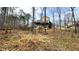 Backyard view of home with a deck overlooking a wooded area at 679 Victorian Cir, Dallas, GA 30157