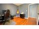 Bedroom showcasing hardwood floors, an easel, and a doorway at 679 Victorian Cir, Dallas, GA 30157