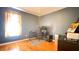 Bedroom featuring hardwood floors, a window, and a desk setup at 679 Victorian Cir, Dallas, GA 30157