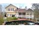 Two-story home with gazebo-style porch overlooking a fish pond with brick surround at 679 Victorian Cir, Dallas, GA 30157