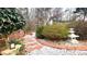 Stone pathway with white gravel winding through a lush garden with oriental accents at 679 Victorian Cir, Dallas, GA 30157