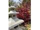 Garden scene with decorative stone pagoda and blooming burgundy loropetalum shrubs at 679 Victorian Cir, Dallas, GA 30157
