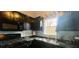Kitchen featuring black appliances and countertops, with plenty of natural light at 679 Victorian Cir, Dallas, GA 30157