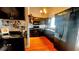 Well-equipped kitchen with dark cabinetry, modern appliances, and wood-style flooring at 679 Victorian Cir, Dallas, GA 30157