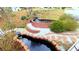 Backyard koi pond with red brick edging, stepping stones, a small waterfall feature, and lush landscaping at 679 Victorian Cir, Dallas, GA 30157