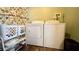 Laundry room with washer, dryer, and shelving at 679 Victorian Cir, Dallas, GA 30157