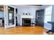 Living room with hardwood floors, fireplace, and open doorway to kitchen at 679 Victorian Cir, Dallas, GA 30157