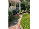 Landscaped backyard features a decorative pond with brick surround and lush greenery at 679 Victorian Cir, Dallas, GA 30157