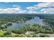 Expansive aerial view showcasing a lakeside community with pool, mature trees and sparkling water at 820 Thermopylae Ct, Alpharetta, GA 30005