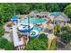 Aerial view of the community pool with slides, lounge chairs, and ample seating at 820 Thermopylae Ct, Alpharetta, GA 30005