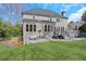 Expansive backyard with stone patio, seating area, and lush green lawn at 820 Thermopylae Ct, Alpharetta, GA 30005