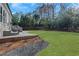 Nicely landscaped backyard with a stone patio area and lush green grass at 820 Thermopylae Ct, Alpharetta, GA 30005