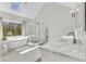 Bright bathroom with modern soaking tub, glass shower, and marble countertops at 820 Thermopylae Ct, Alpharetta, GA 30005