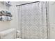 Bathroom featuring a white toilet, shower, and decorative curtain at 820 Thermopylae Ct, Alpharetta, GA 30005