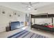Bright bedroom with a bunk bed, blue dresser, and accent wall decorations at 820 Thermopylae Ct, Alpharetta, GA 30005