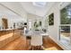 Dining area includes modern table, vaulted ceiling, and backyard view, adjacent to the kitchen at 820 Thermopylae Ct, Alpharetta, GA 30005